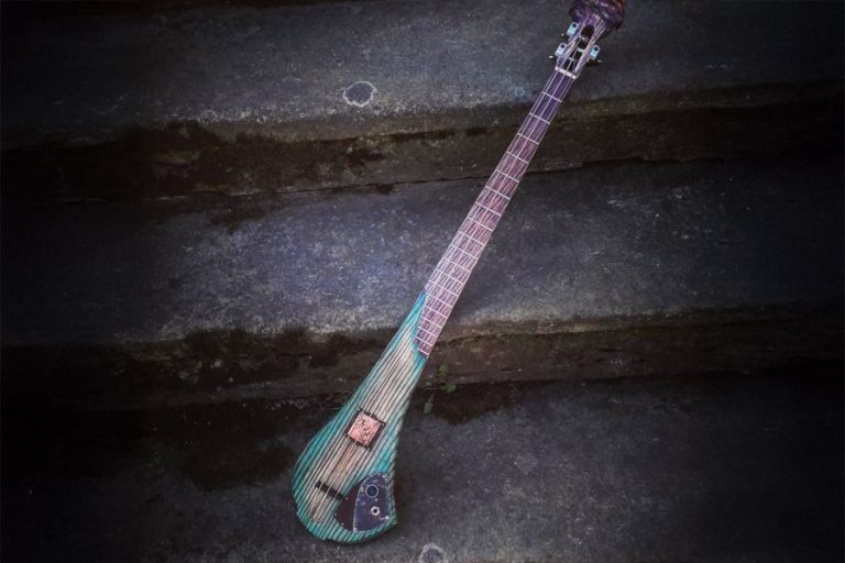 Bass of the Week: A 3-String Bass Carved from a Single Slab – with a Snarling Headstock